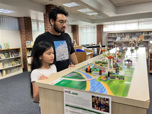 girl looking at LEGO