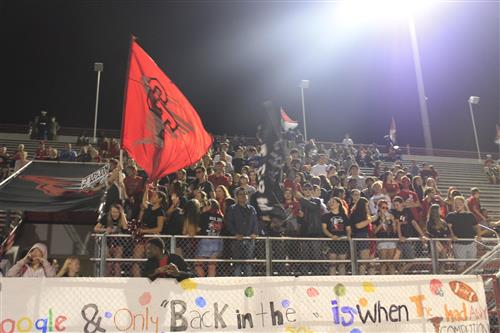 students in stands at football game 