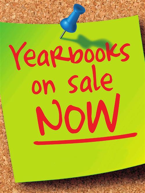  A bright green post it note on cork board with red text Yearbooks On Sale