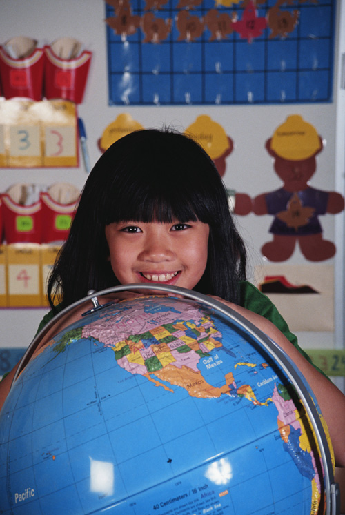 Girl and a globe in class