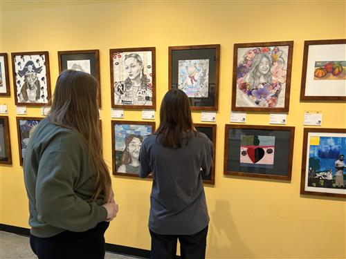  students looking at artwork