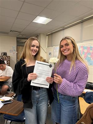 Student presenting invitation to student