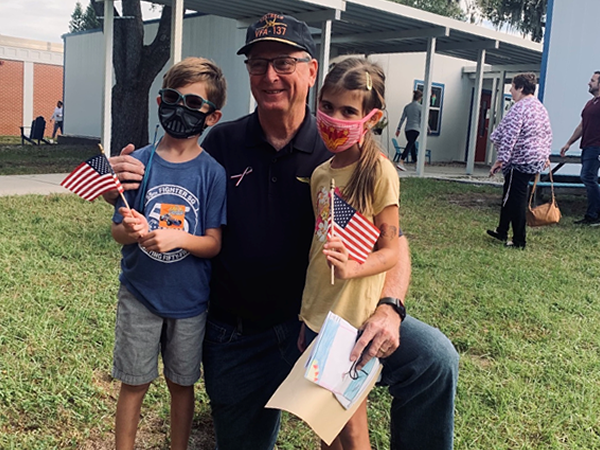 Anona Elementary students with a Veteran during the Veterans Day Celebration.