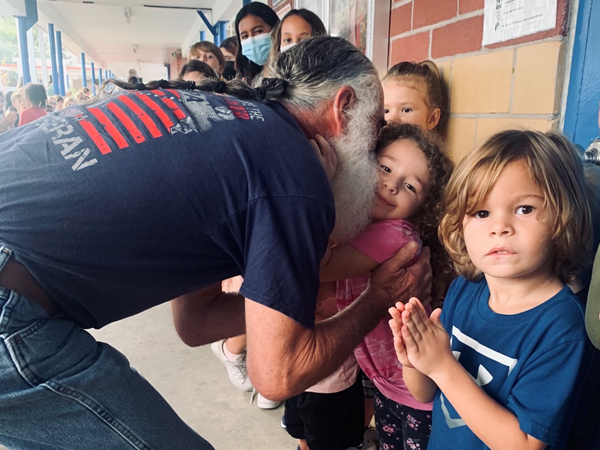 Anona Elementary student gets a hug from a Veteran during the Veterans Day Celebration.