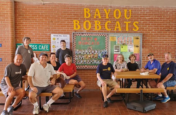 Members of the Pinellas Park Rotary Club assembled eight picnic tables and erected school colored umbrellas at Cross Bayou Elementary.