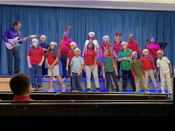 Sandy Lane Elementary Principal, Dr. Moss playing guitar at the holiday concert!