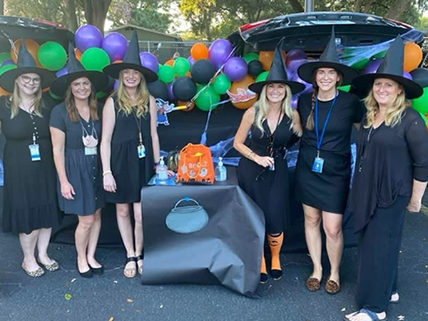 Plumb Elementary staff dressed as witches at the school Trunk or Treat.