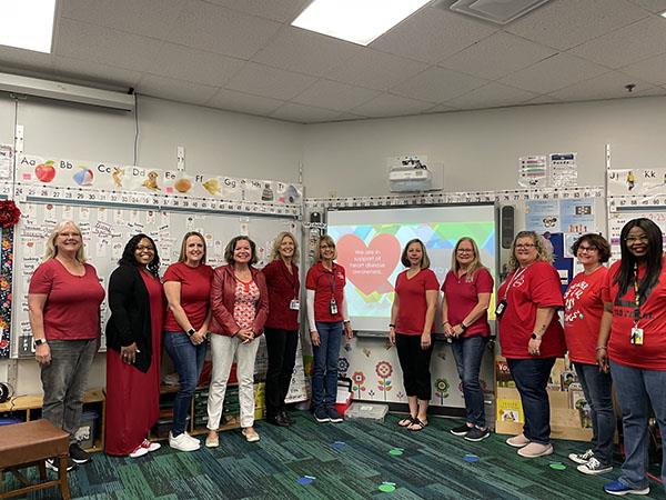 Eisenhower Elementary staff wore red to support Heart Disease Awareness. Special recognition to Mary Frank, VE Resource Teacher (left center), who is a 50-gallon blood donor.