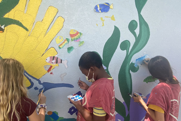 PCS Visual Arts Summer Mural Camp students worked with Angela Cannata to paint a mural at Blanton Elementary School.