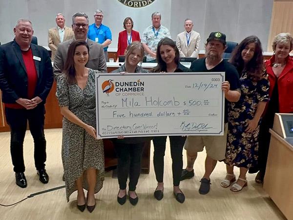 Mila Holcomb, an 8th-grade student at Dunedin Highland Middle School, was recognized at Dunedin City Hall during a City Commission Meeting for having her artwork selected for the cover of the Dunedin Chamber of Commerce 2025 Directory.